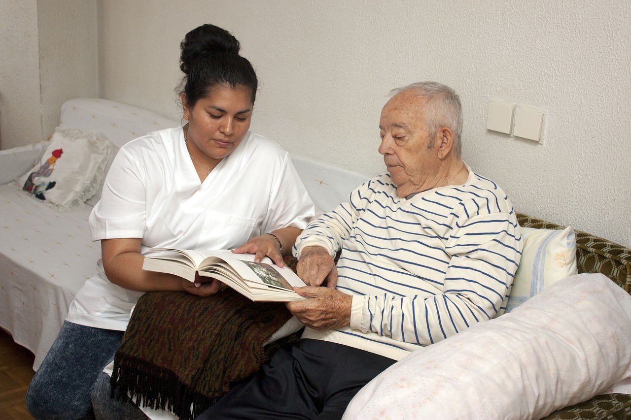 Caregiver assisting an old man with dementia