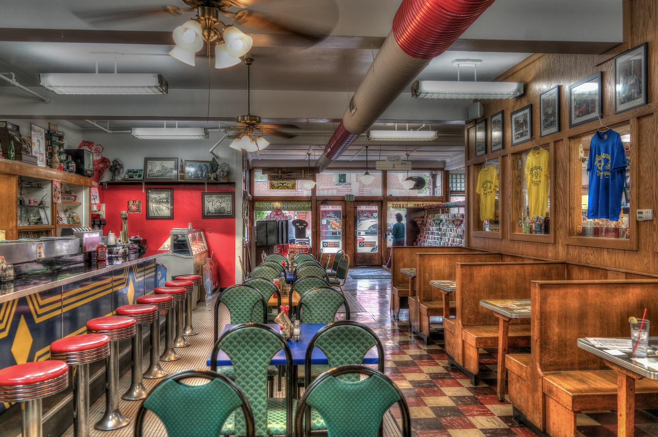 A classic diner with counter, stools, tables, and booths.