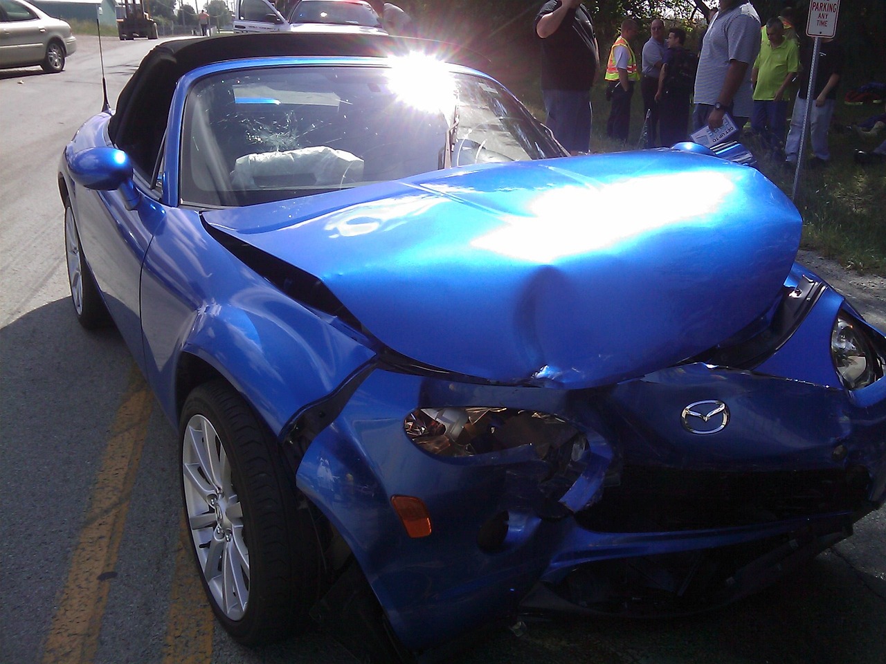 A crumpled blue car, a stark reminder of a DUI accident's devastating consequences