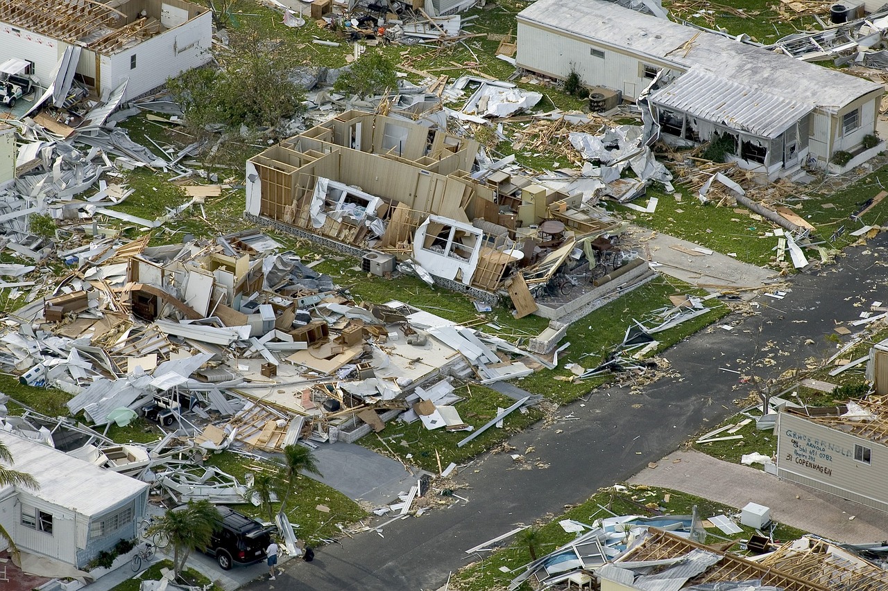 Devastating hurricane aftermath: splintered homes, shattered roofs, and debris-filled streets.