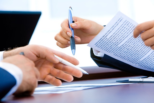nsurance agent consulting with client, reviewing policy documents