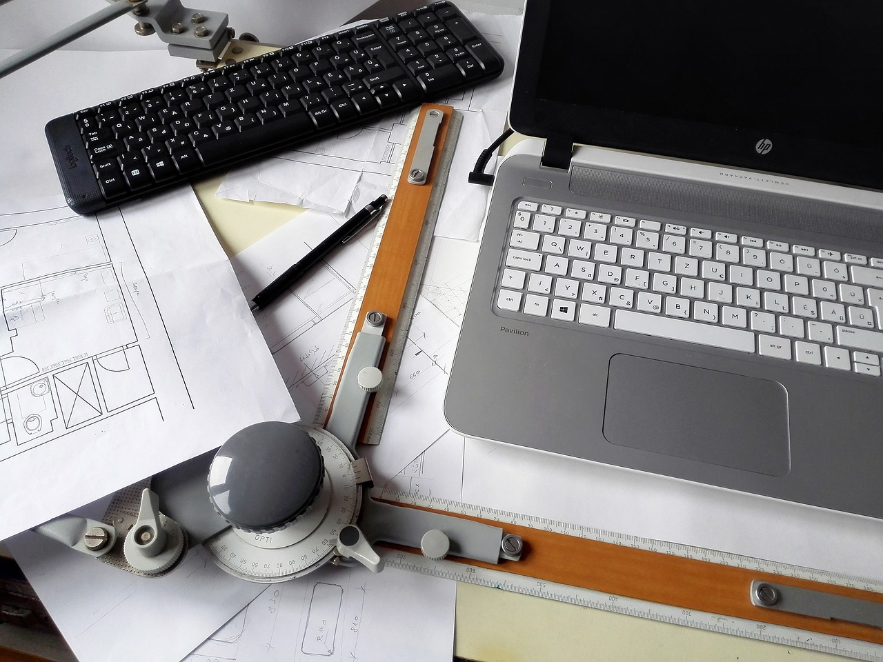 Engineering consultant's office workspace, showcasing a blend of technology and traditional design tools