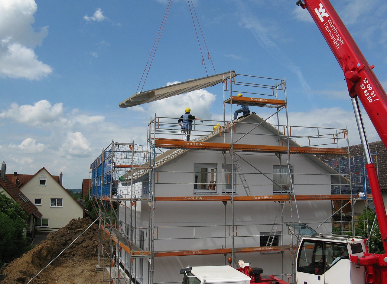 Engineer supervising roof installation on construction site.