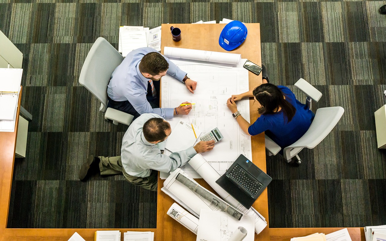Quality control: Engineers cross-checking construction plans.