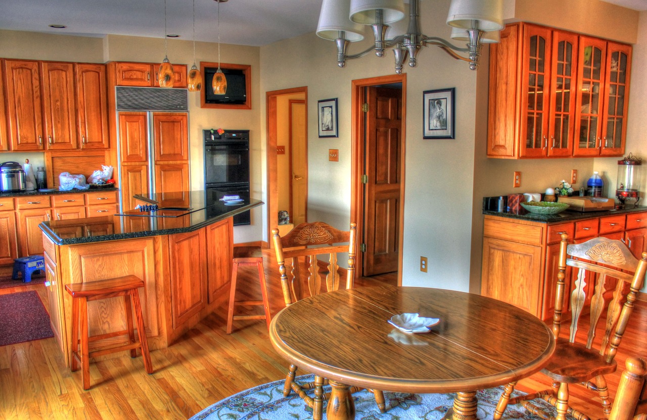 Apartment interior featuring rich, wooden flooring, furniture and cabinetry.