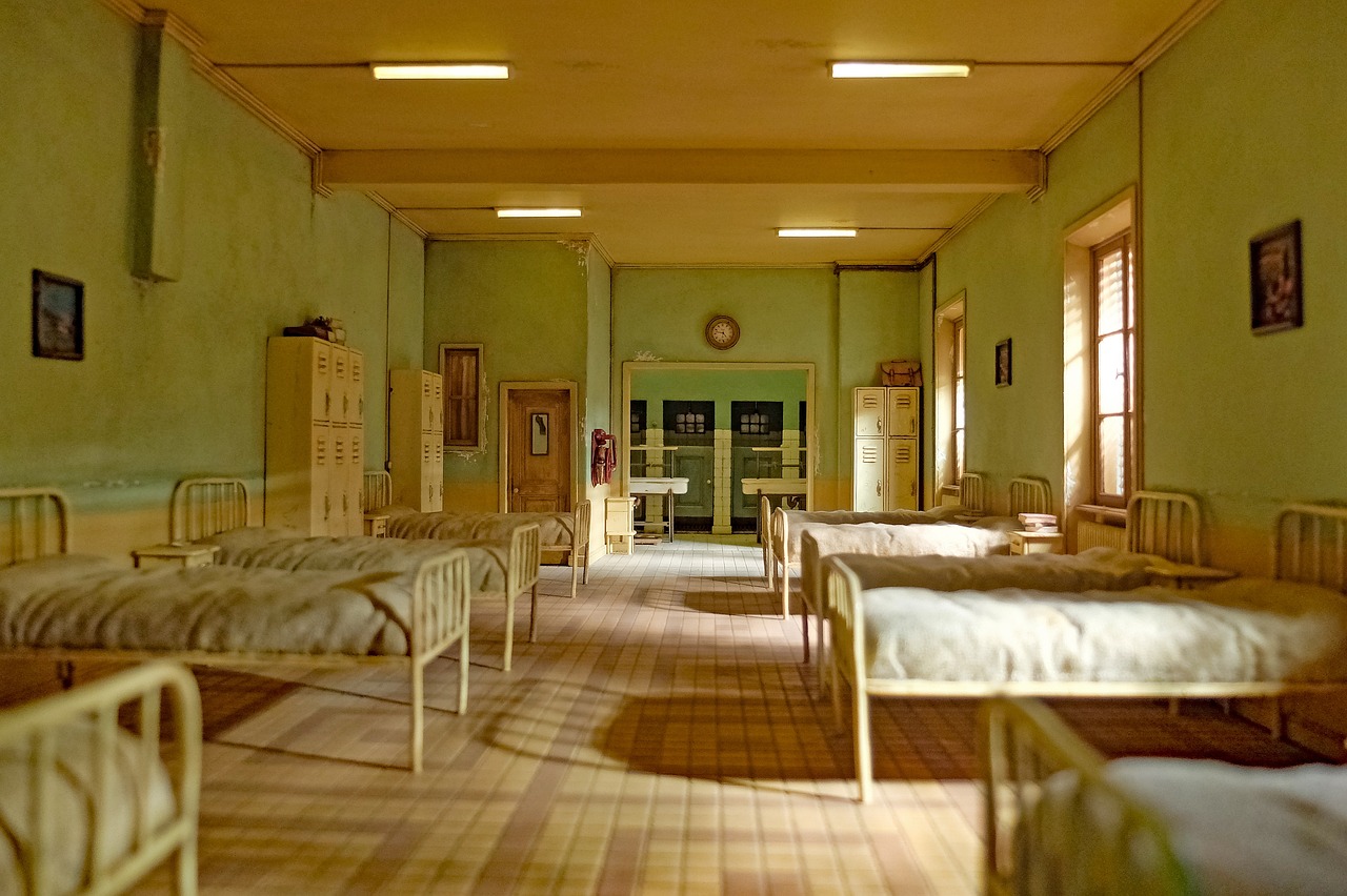 A halfway house dormitory with neatly arranged beds for residents.