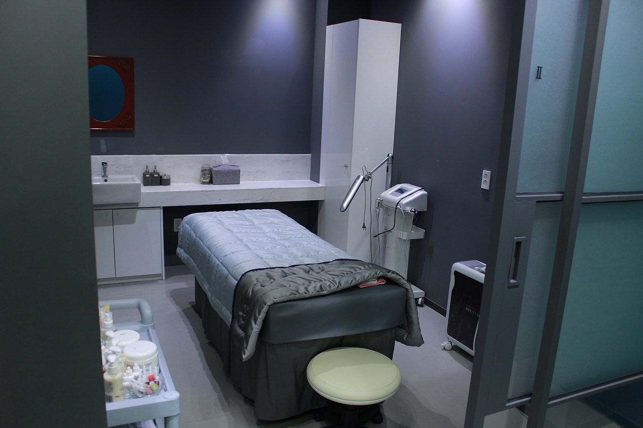 Modern dermatologist clinic with examination bed and advanced medical equipment.
