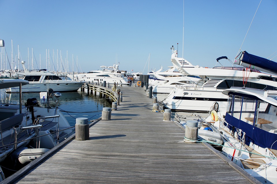 Upscale marina featuring high-end boats and luxurious watercraft.