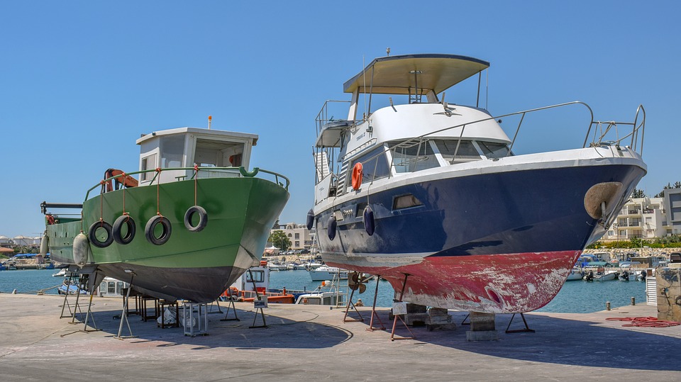 Boats in dry dock, undergoing repairs and refurbishment.