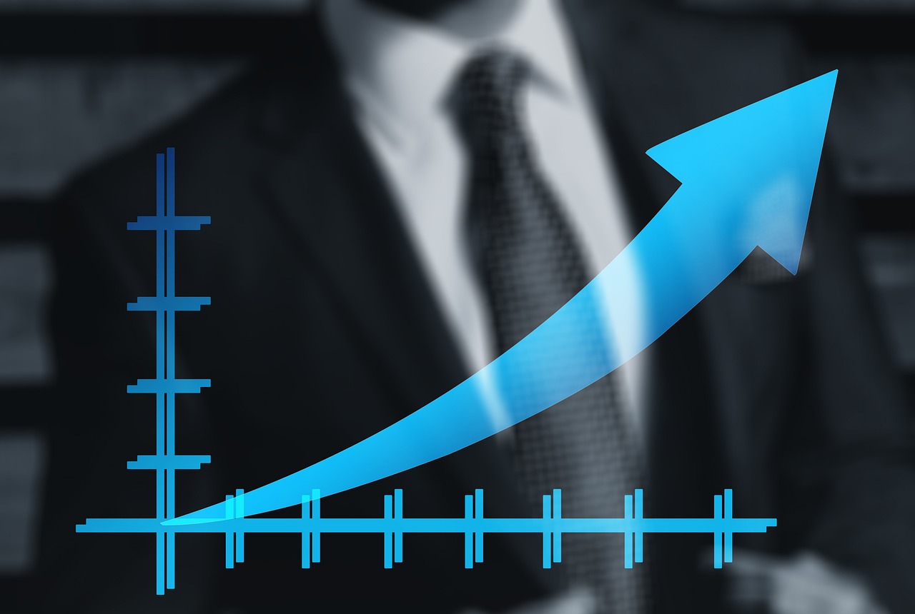Businessman in background, upward graph trend illustrates M&A insurance supporting business growth.