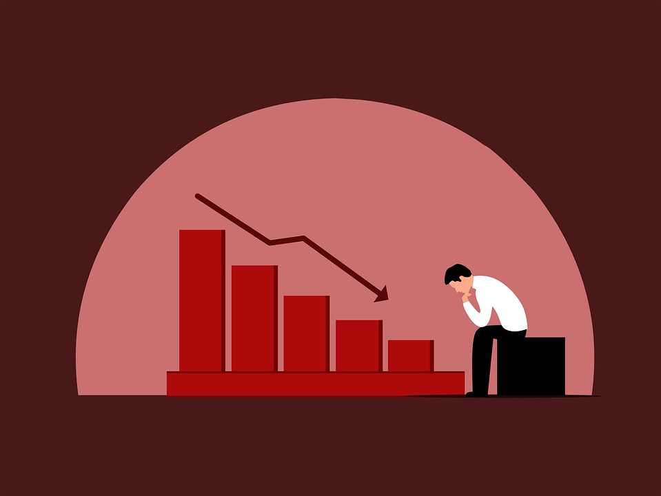 Financial advisor stares at downward trending graph, overcome with worry as investment strategy backfires.