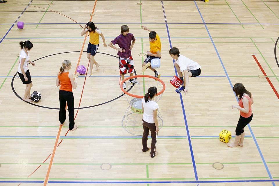 Parents lend a hand at Montessori school games activity.
