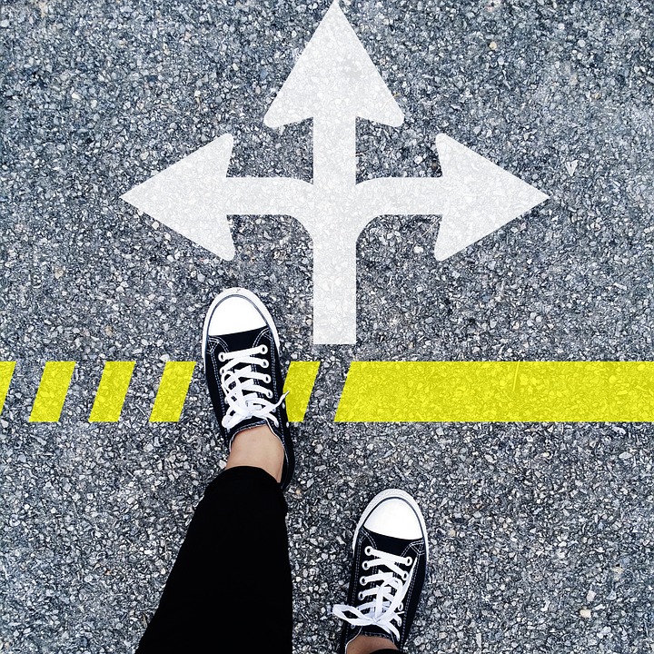 A person takes a step forward, facing three diverging paths, representing multiple choices.