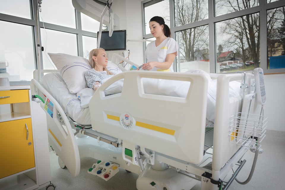 Nurse provides compassionate care to patient recovering in hospital bed.