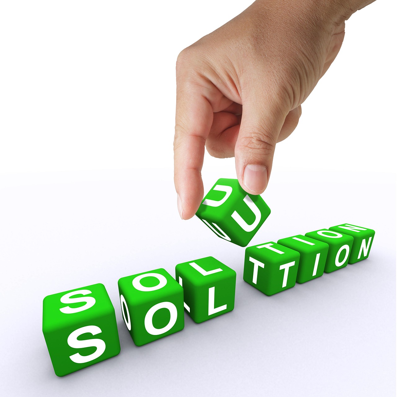 A hand placing a "U" block into the word "solution", highlighting the importance of unique perspectives and tailored solutions.