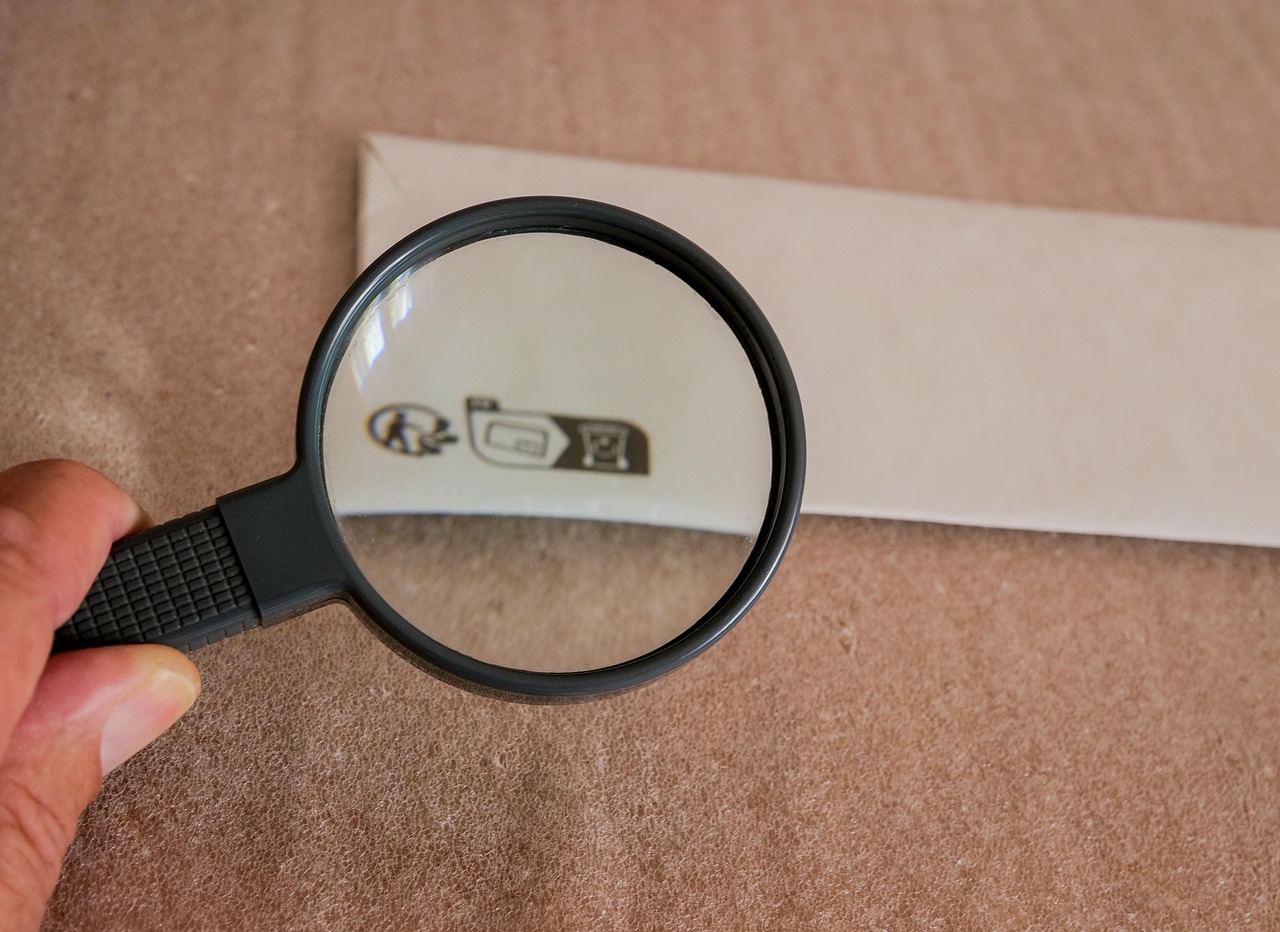 Policy terms and conditions under the magnifying glass, symbolizing careful review.