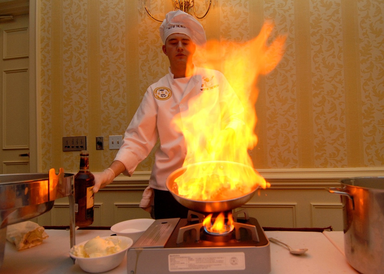 Chef adding a flambé finish