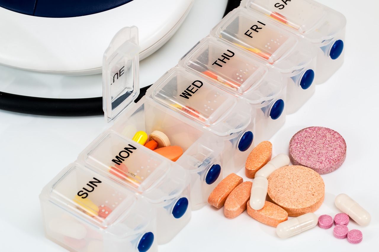 A tablet organizer, labeled with the days of the week, neatly stores and dispenses dietary supplements