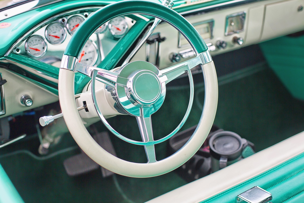 Vintage car interior with three-spoke steering wheel and classic analog dashboard dials