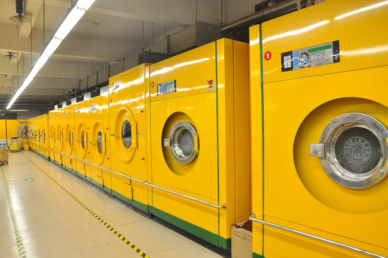 Row of commercial washing machines at a laundromat