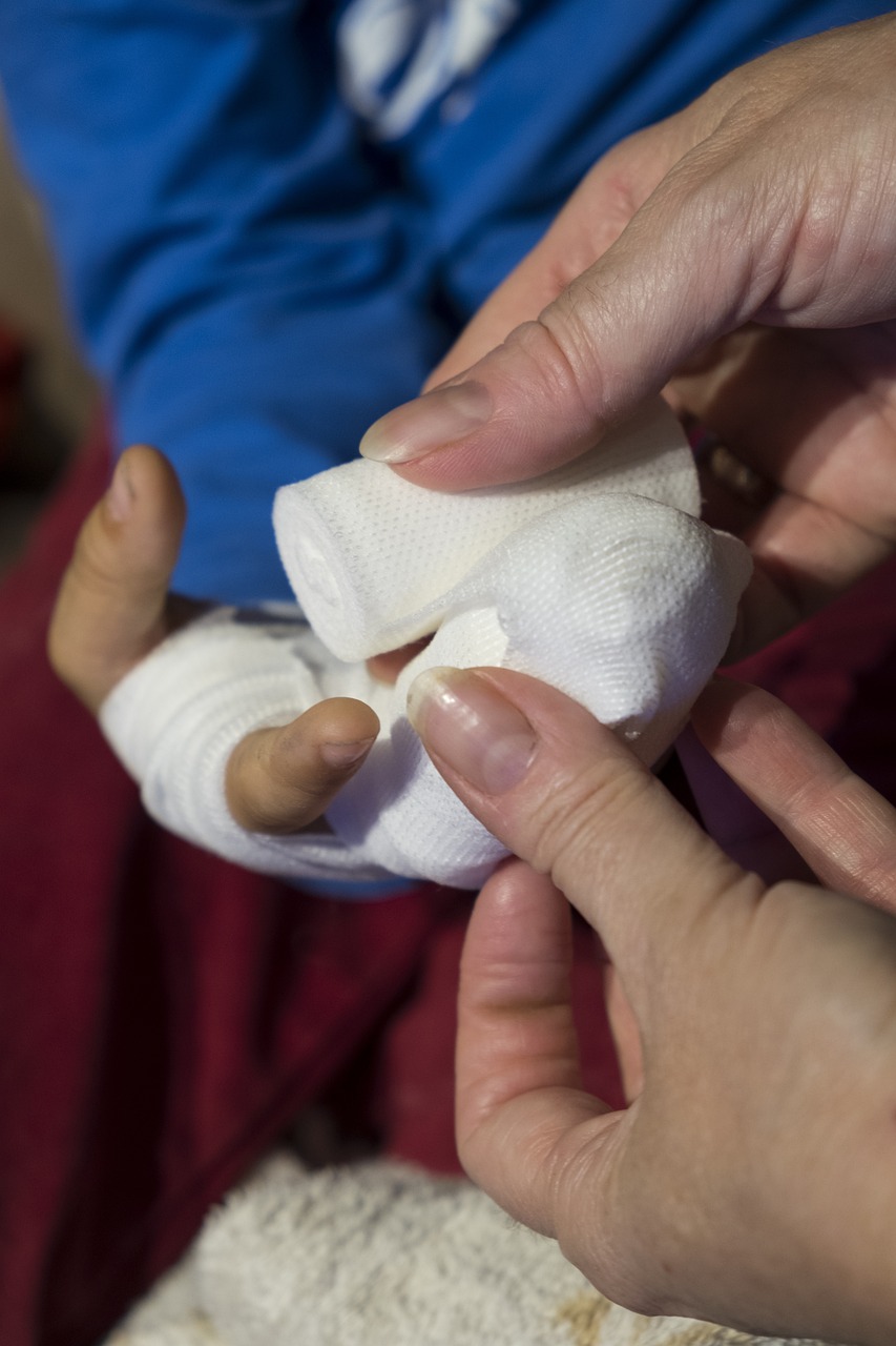 On-the-Job Injury: Drywall Worker's Hand Being Bandaged"