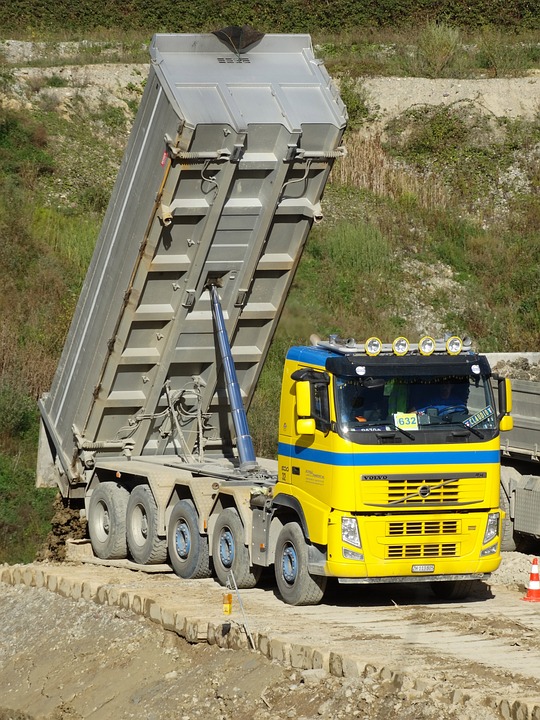 Dump Truck Drops Waste into Deep Construction Pit