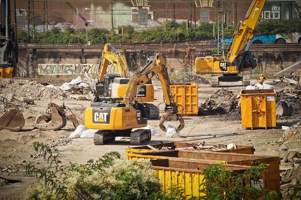 Construction Site Activity: Dumpsters Being Filled with Debris