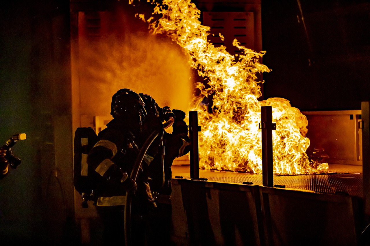 Rental property fire: firefighter working to put out the flames.