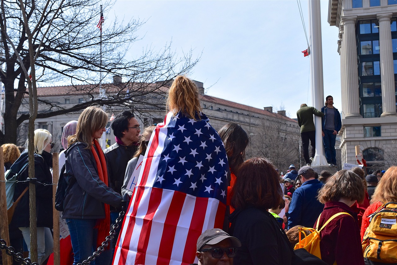 Group of students exercising freedom of expression on campus, including American flag display