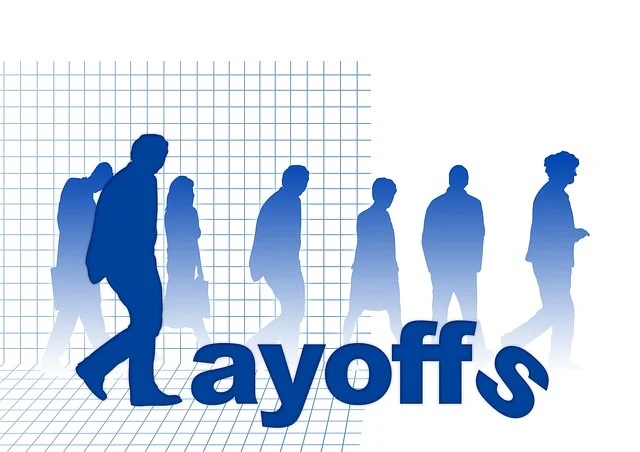 Shadowy figures representing laid-off workers, symbolizing uncertainty