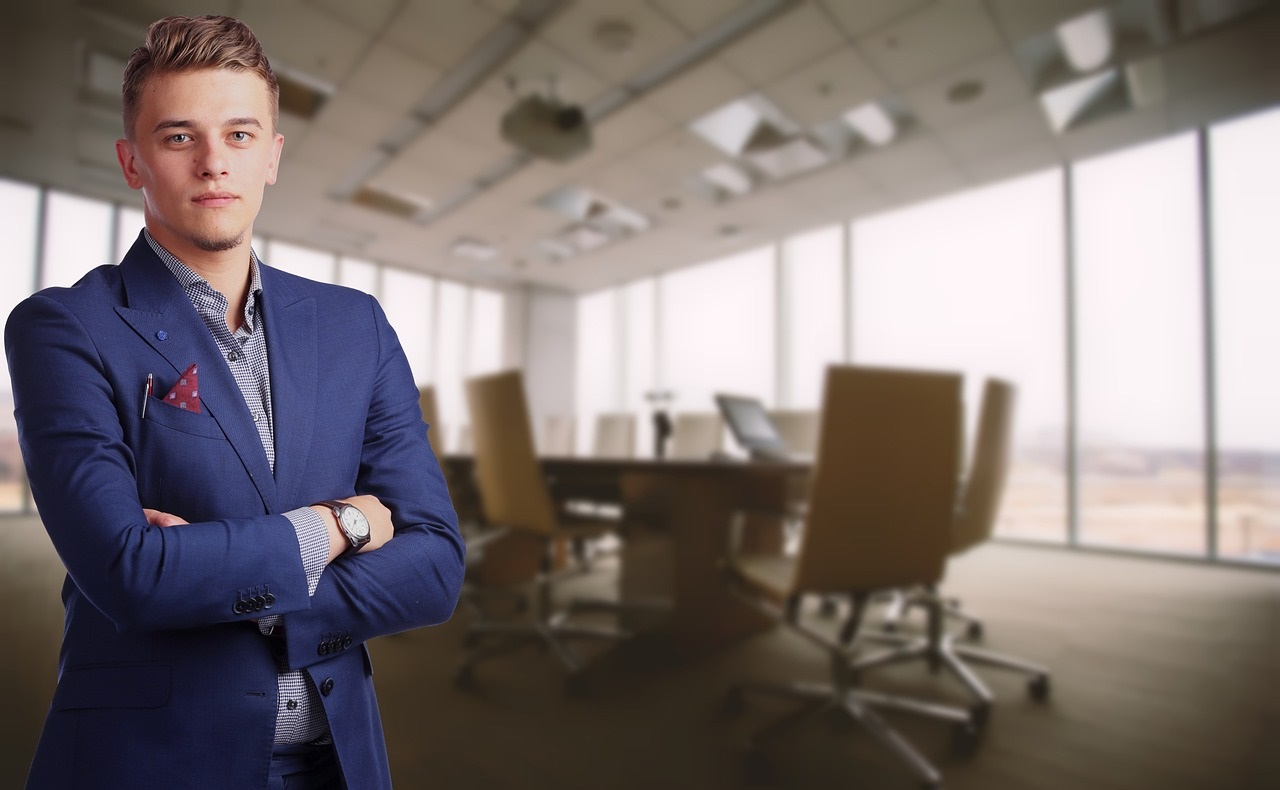 Successful entrepreneur with a thoughtful expression, boardroom visible in background