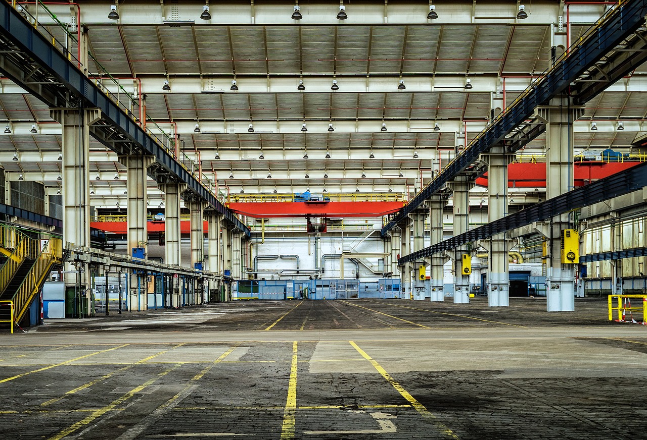 A vast, silent industrial space lies dormant.