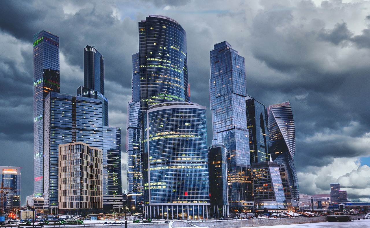 Nighttime cityscape of CBD, featuring illuminated office buildings