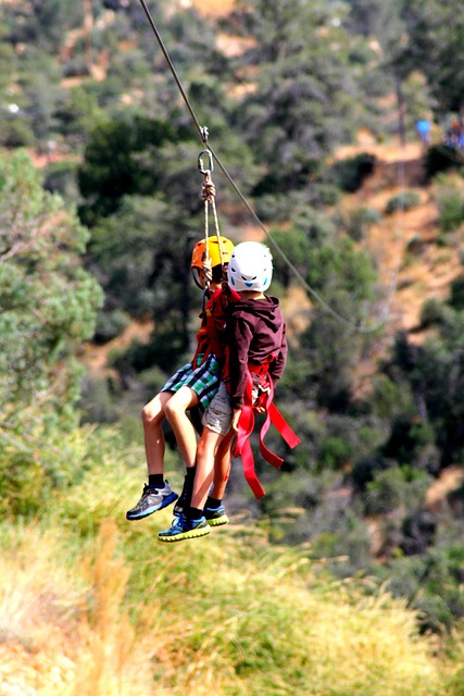 Kids in mid-air on a zip rope course