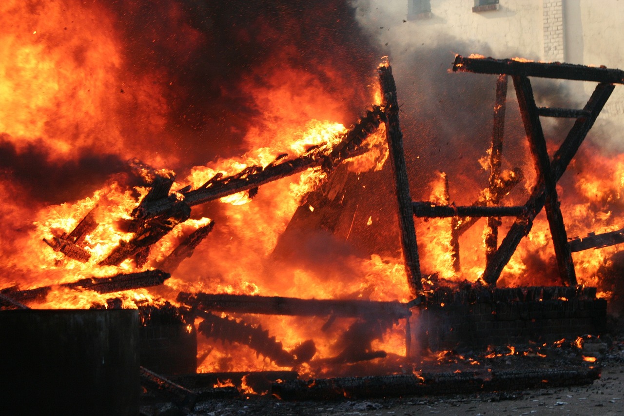A structure engulfed in a raging fire