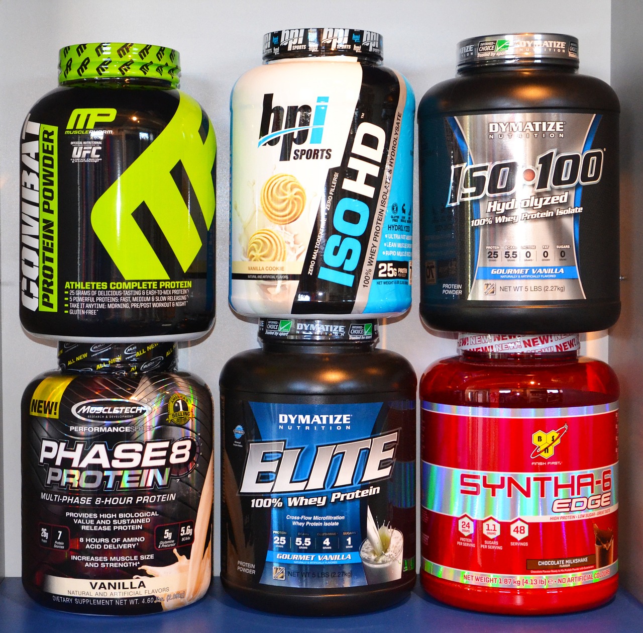nutrition and fitness supplements stacked on top of each othe