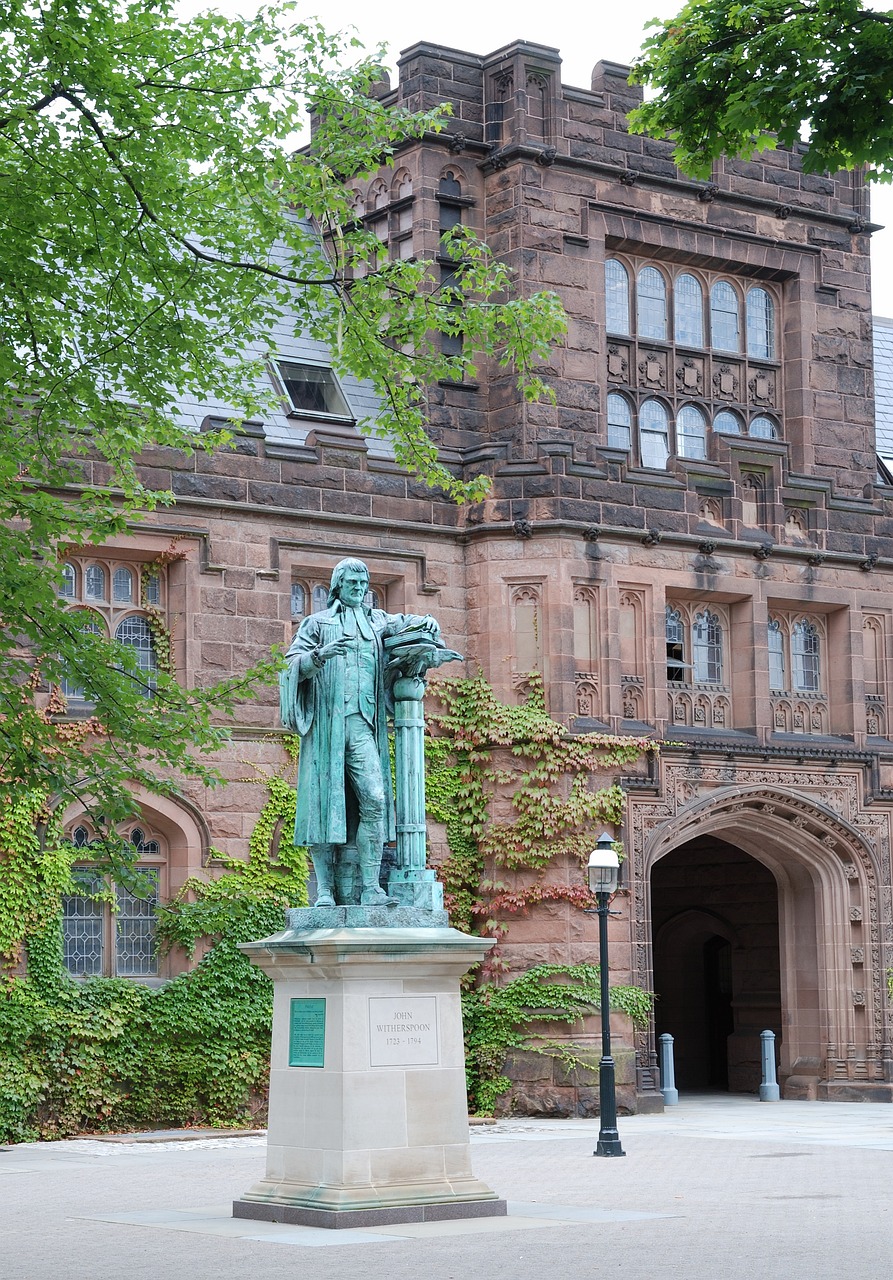Historic building featuring a prominent statue in the foreground.