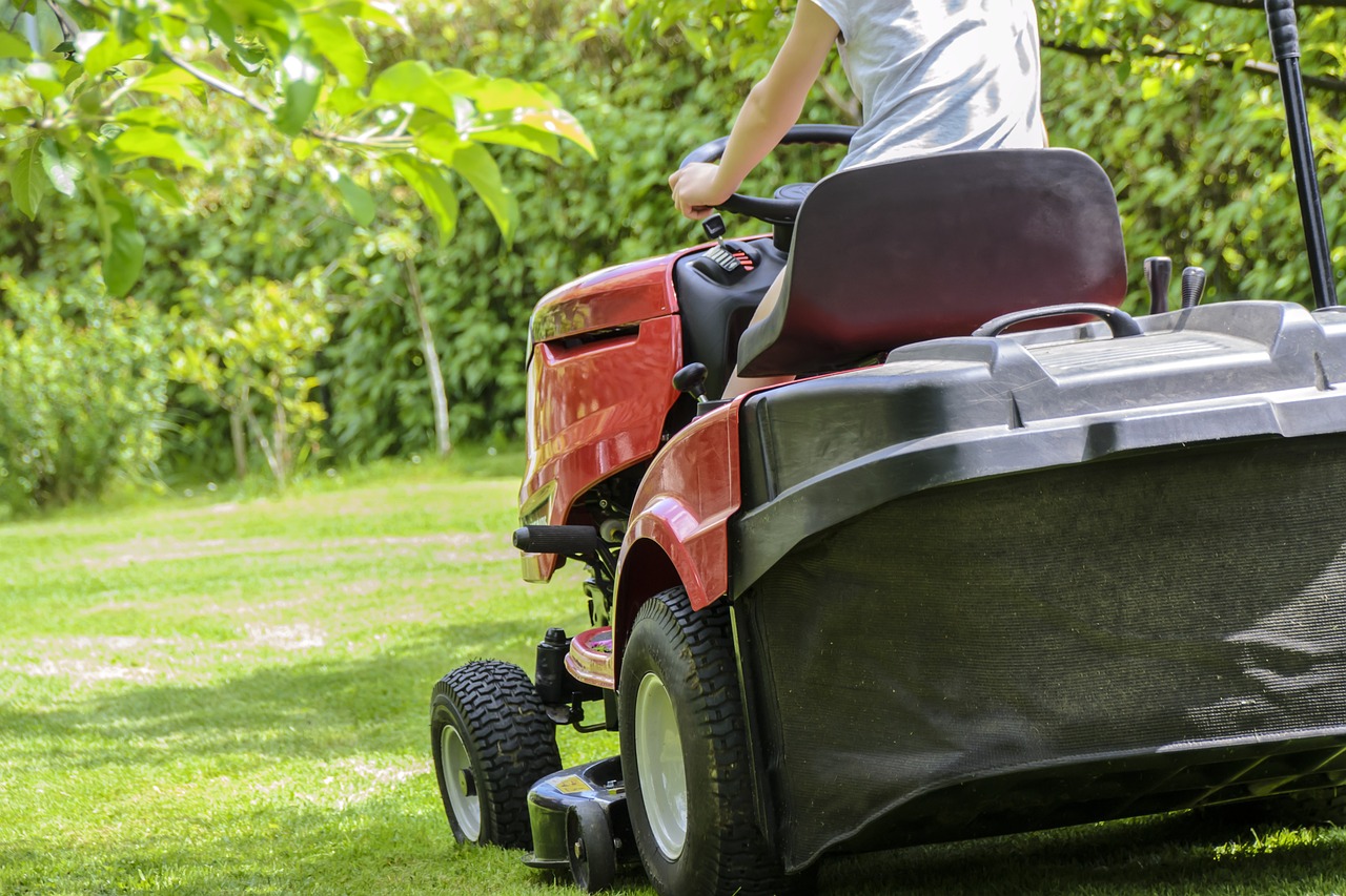 Golf course staff operating a lawn mower