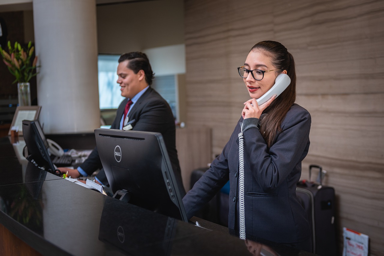 Hotel receptionists at work managing check-ins and guest inquiries at the front desk