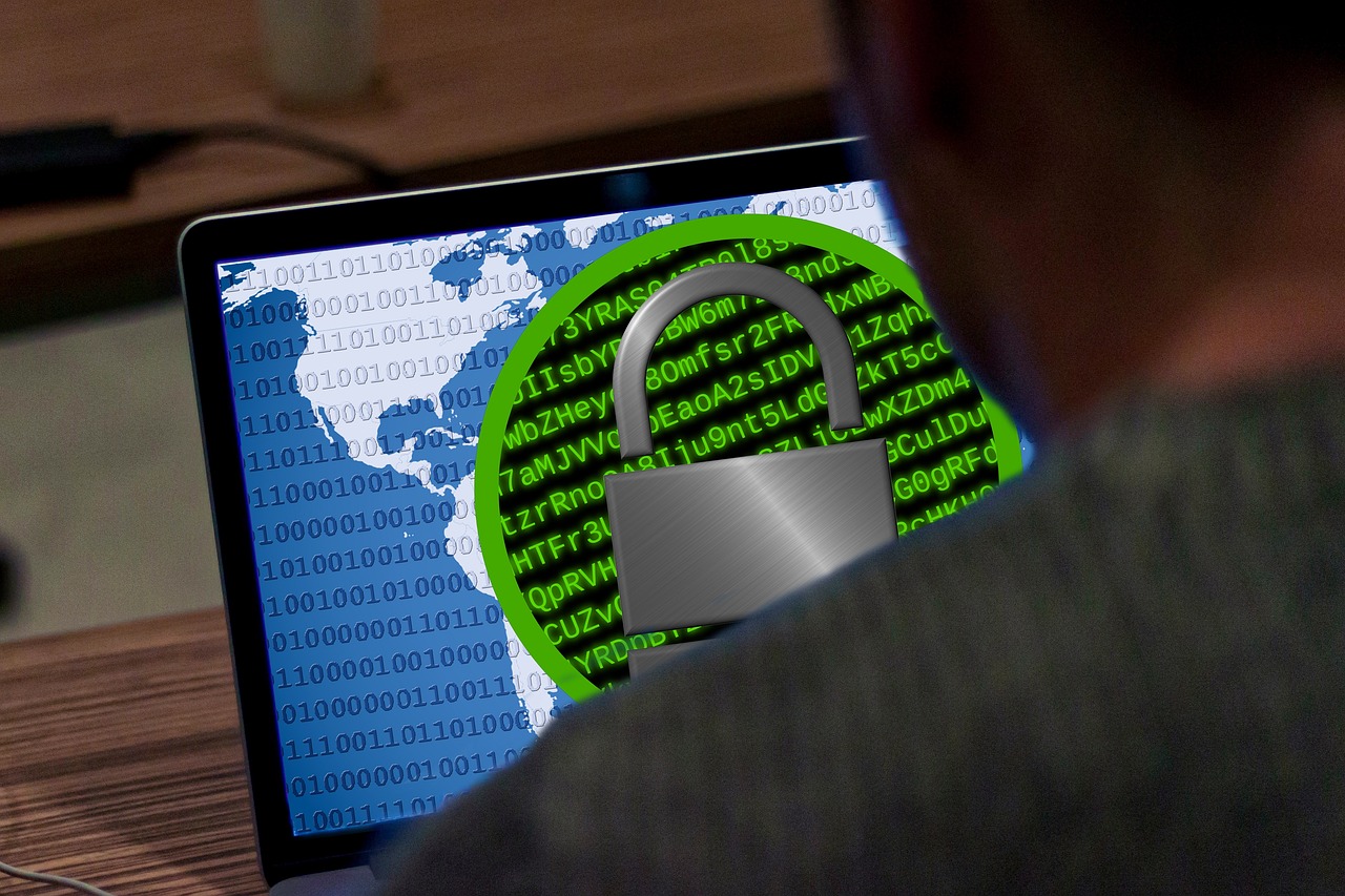 Laptop screen displays a lock icon, indicating a ransomware attack and data breach.