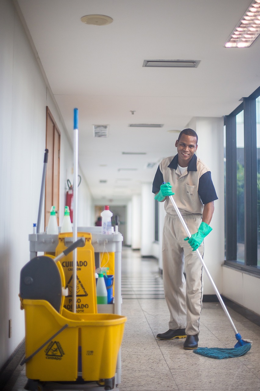 Cleaning professional mopping an office floor