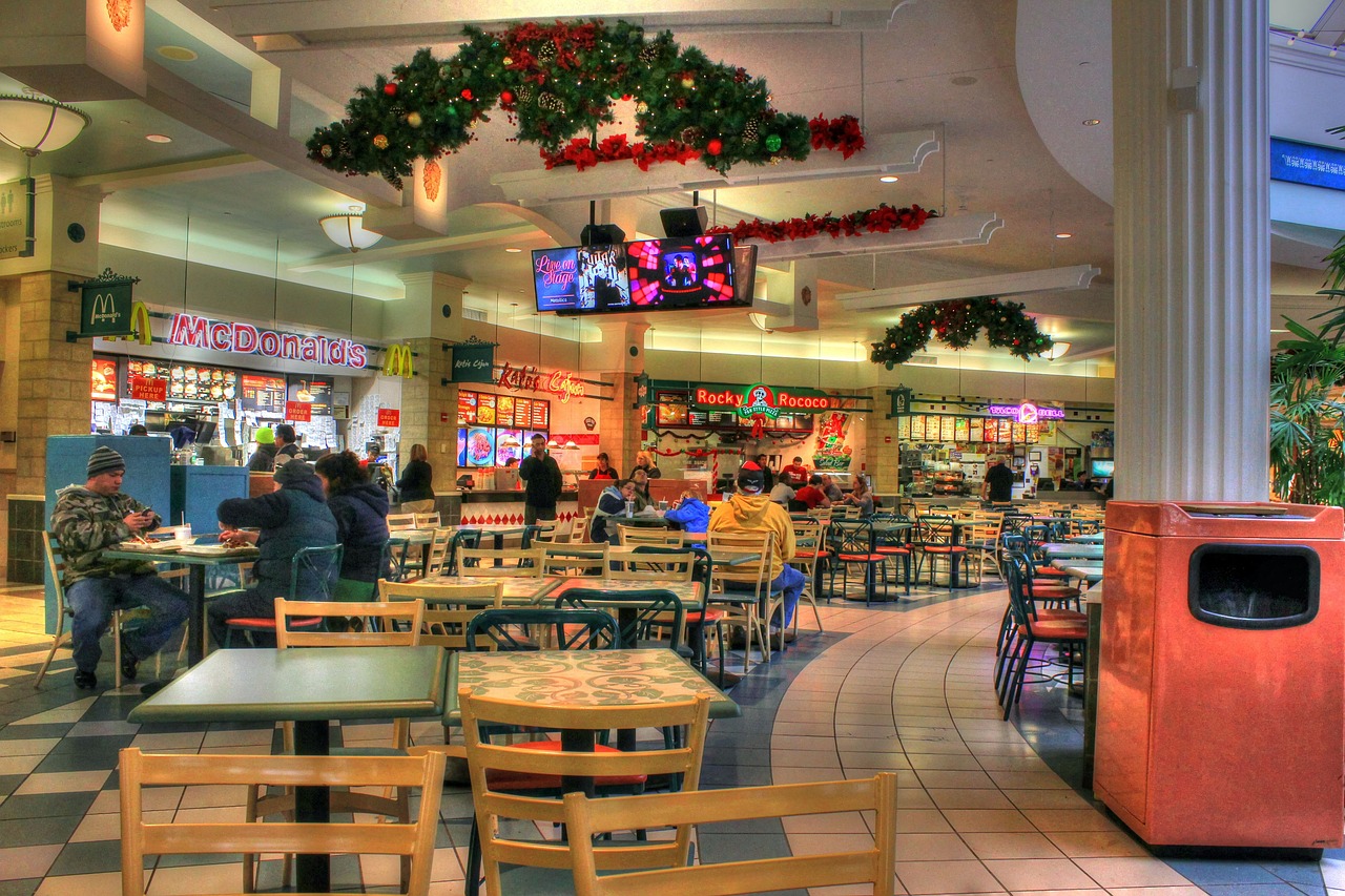 Vibrant food court scene in a mall with multicultural cuisine and relaxed diners