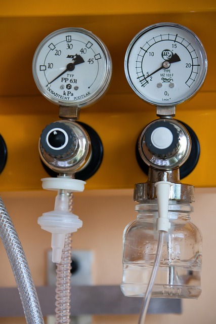 Two round medical gas gauges mounted on a wall in a hospital ward.