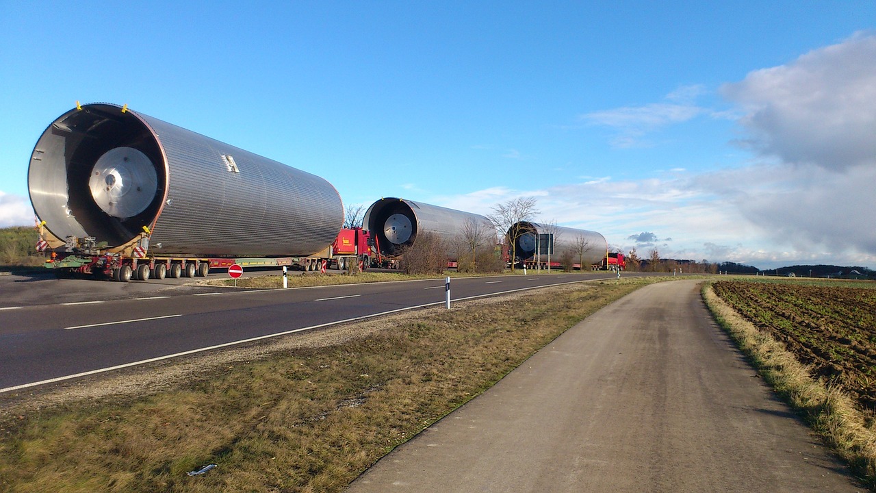 Specialized flatbed trucks transport precision-fabricated metal parts for the aerospace industry