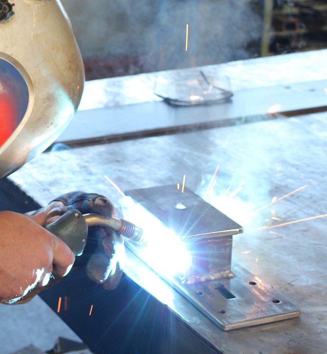 Skilled metalworker meticulously adds finishing touches to a precision-crafted door hardware assembly.