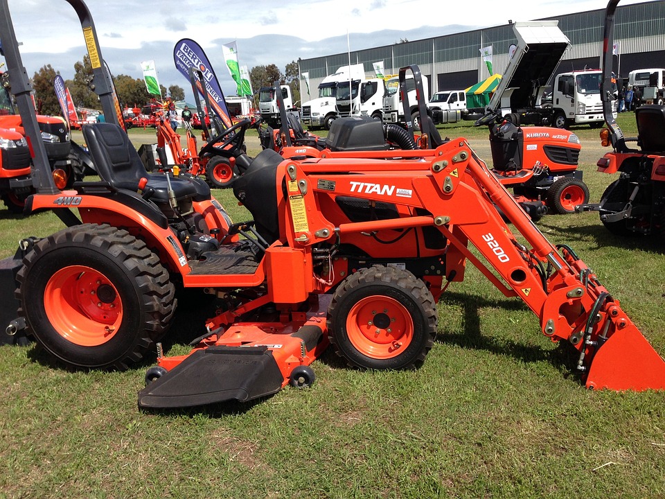Tractor with hole digger and mower