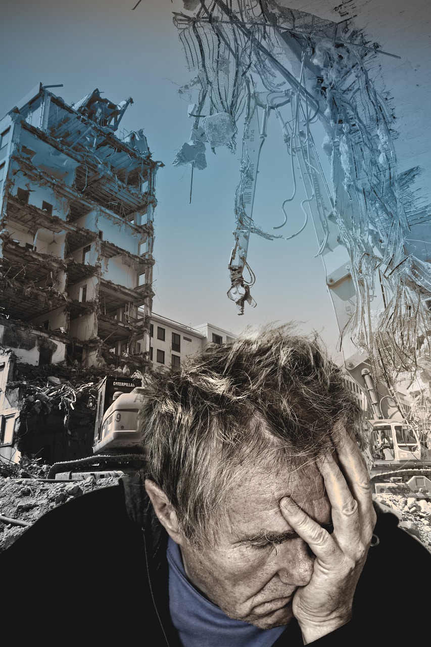 Distraught homeowner stands in front of earthquake rubble