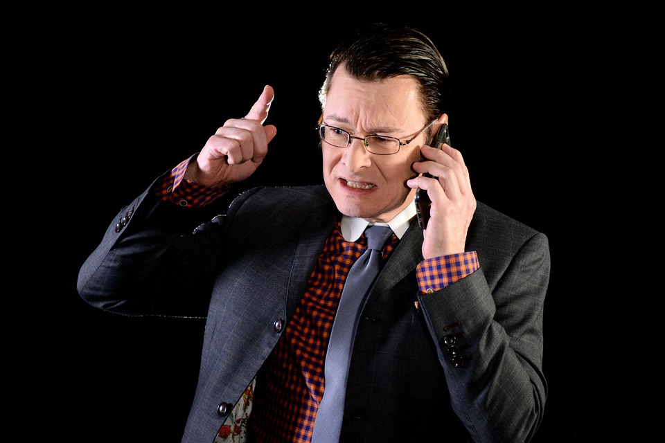 Irate homeowner discusses mortgage concerns with their broker over the phone.