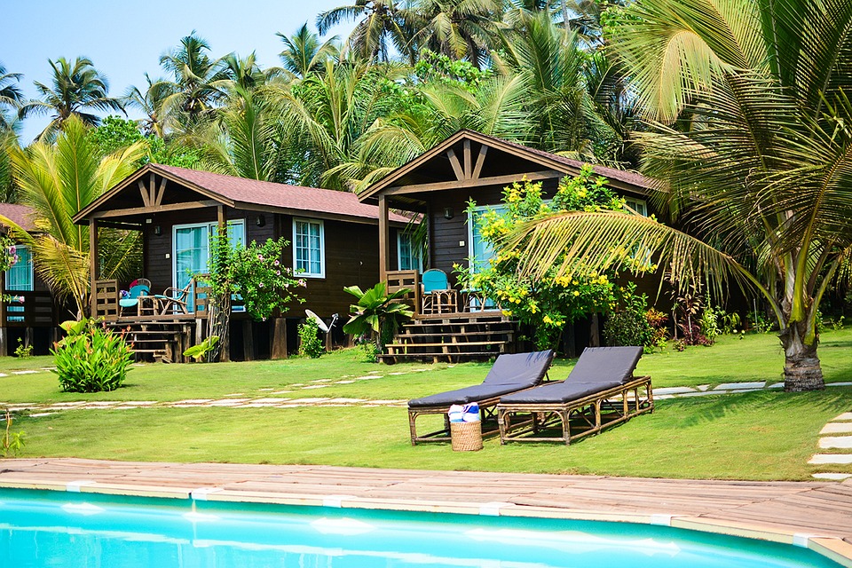 Serene resort motel with cozy cottages and lounge chairs amidst lush surroundings.