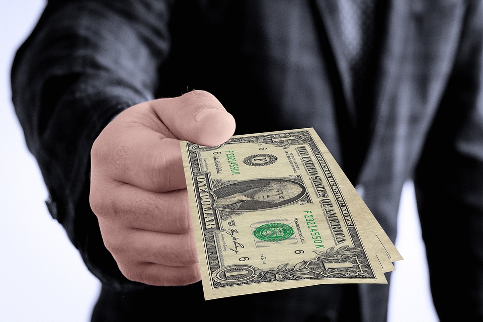 Generous donor presenting a cash gift to support a nonprofit's mission